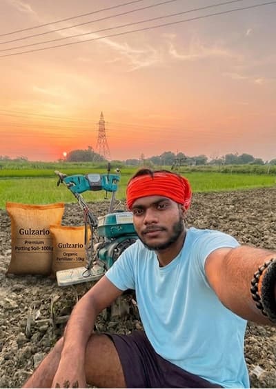 Gulzario founder in the Mirzapur nursery fields with Gulzario potting soil and organic fertilizer sacks at sunset